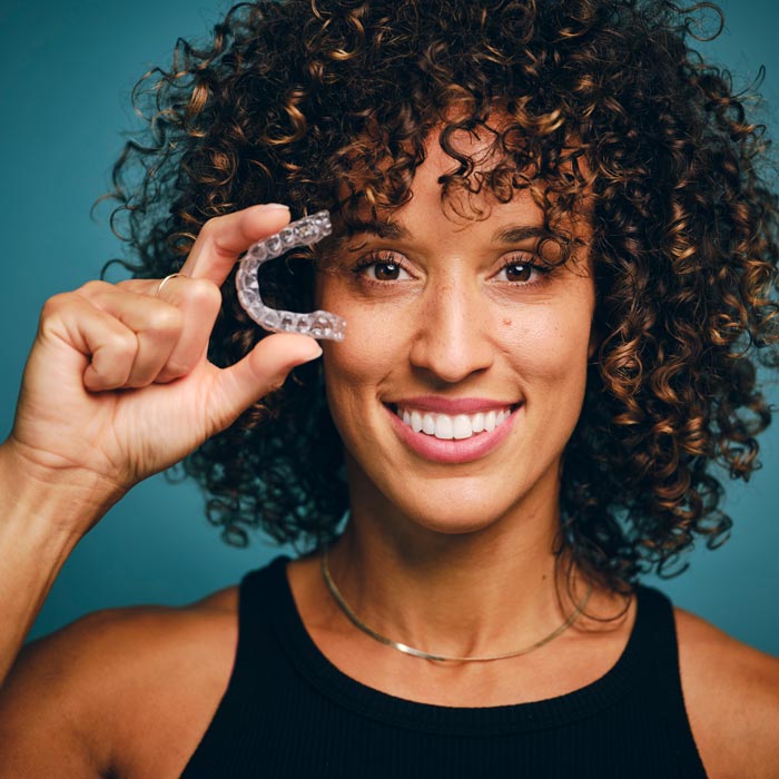 woman with invisalign clear aligners